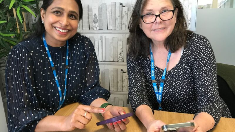 Digital care coordinators Tanuja and Philippa looking at the NHS App on their phones
