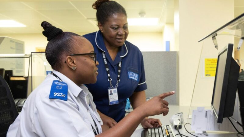 Police officer talks to one of the Metropolitan Police's custody nurses