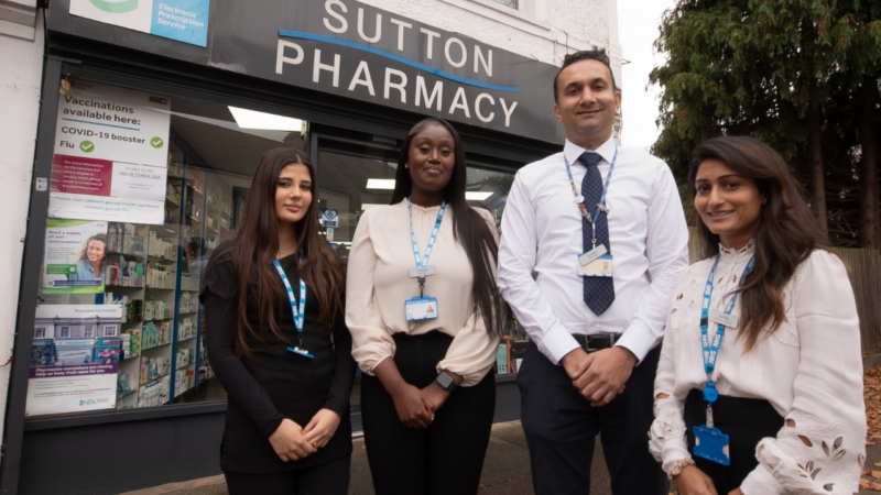 Four pharmacists standing outside Sutton Pharmacy.